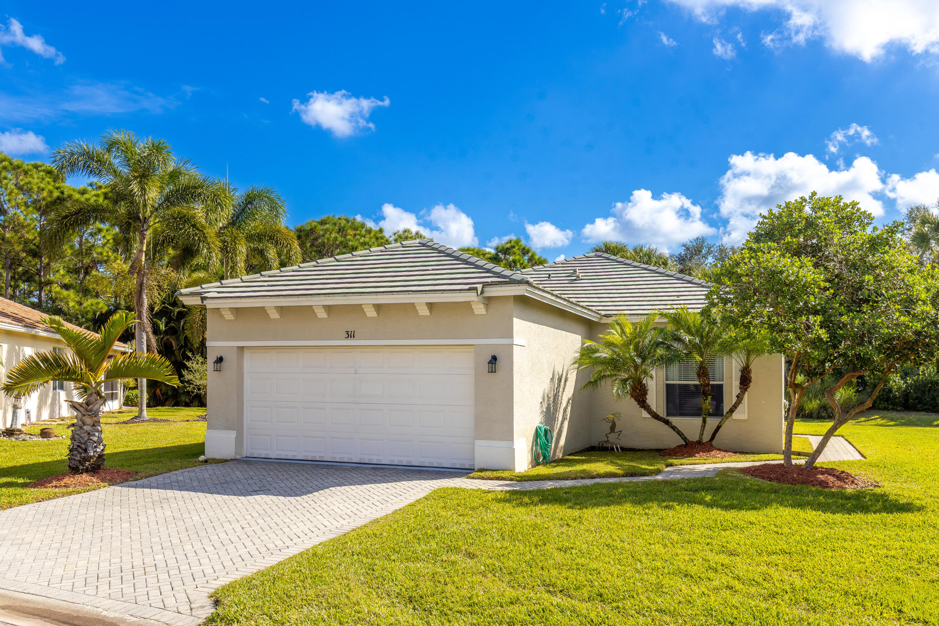 311 Southwest Coconut Key Way Port St. Lucie, FL 34986 - Photo 2 of 25 a front view of a house with a yard