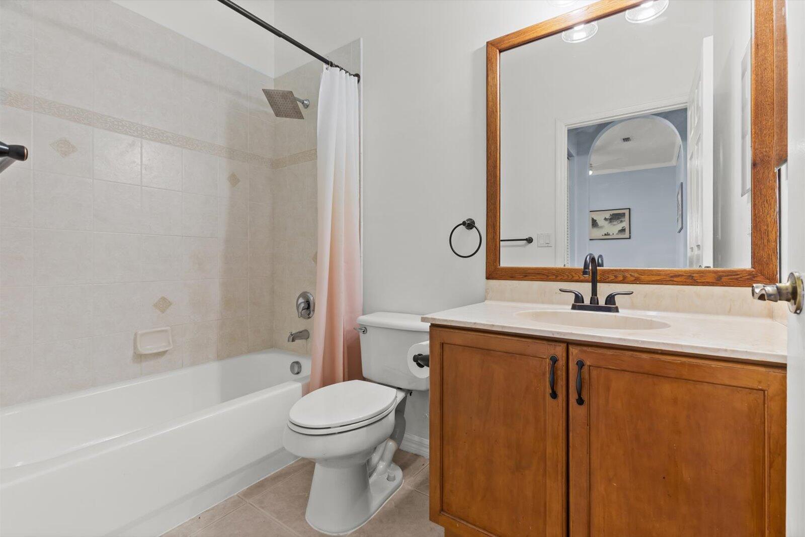 311 Southwest Coconut Key Way Port St. Lucie, FL 34986 - Photo 21 of 25 a bathroom with a granite countertop sink a toilet a mirror and shower