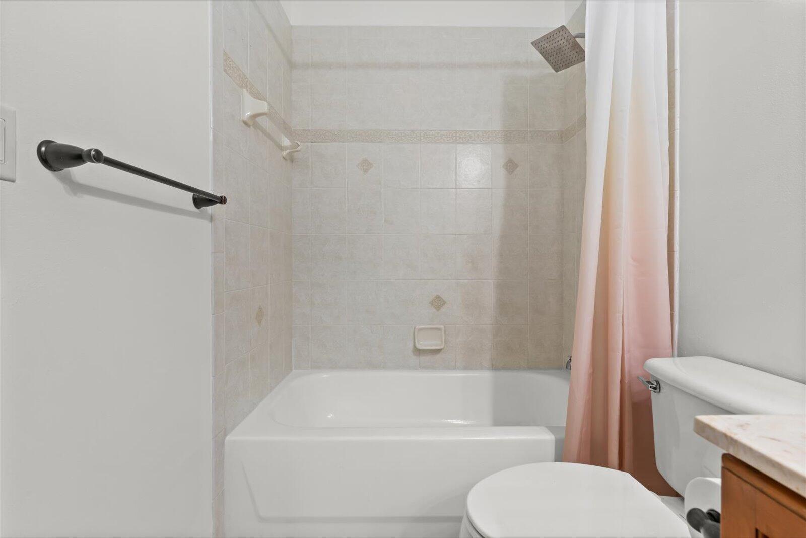 311 Southwest Coconut Key Way Port St. Lucie, FL 34986 - Photo 22 of 25 a bathroom with a toilet and a bath tub