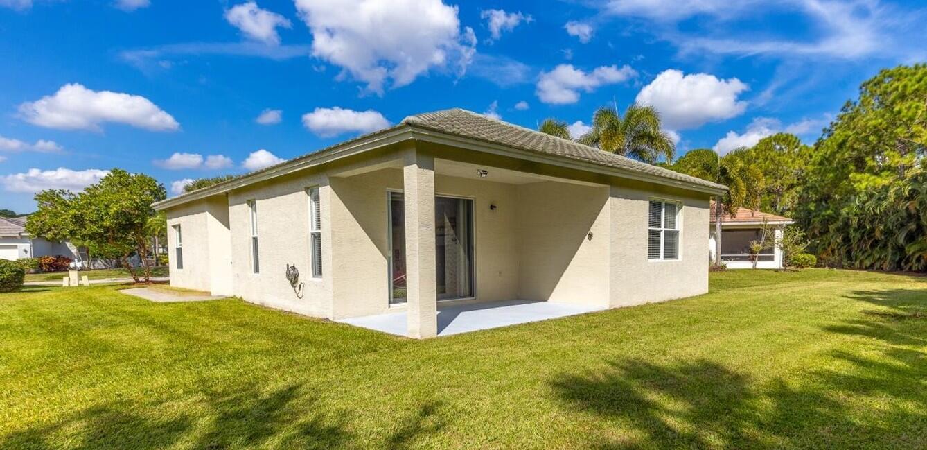 311 Southwest Coconut Key Way Port St. Lucie, FL 34986 - Photo 5 of 25 a front view of a house with a garden
