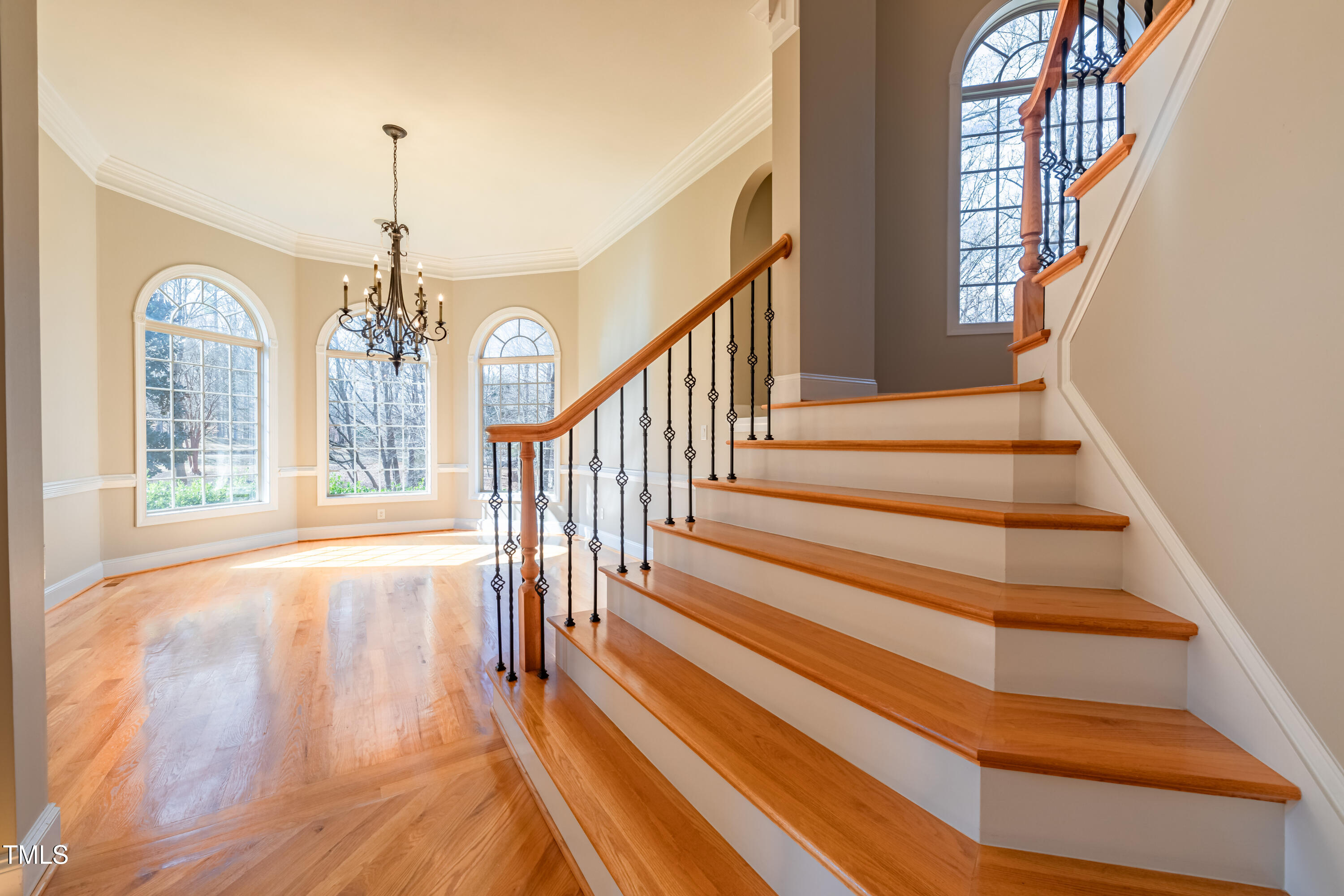 1408 Goldengate Court Raleigh, NC 27613 - Photo 9 of 64 a view of staircase with railing and a chandelier