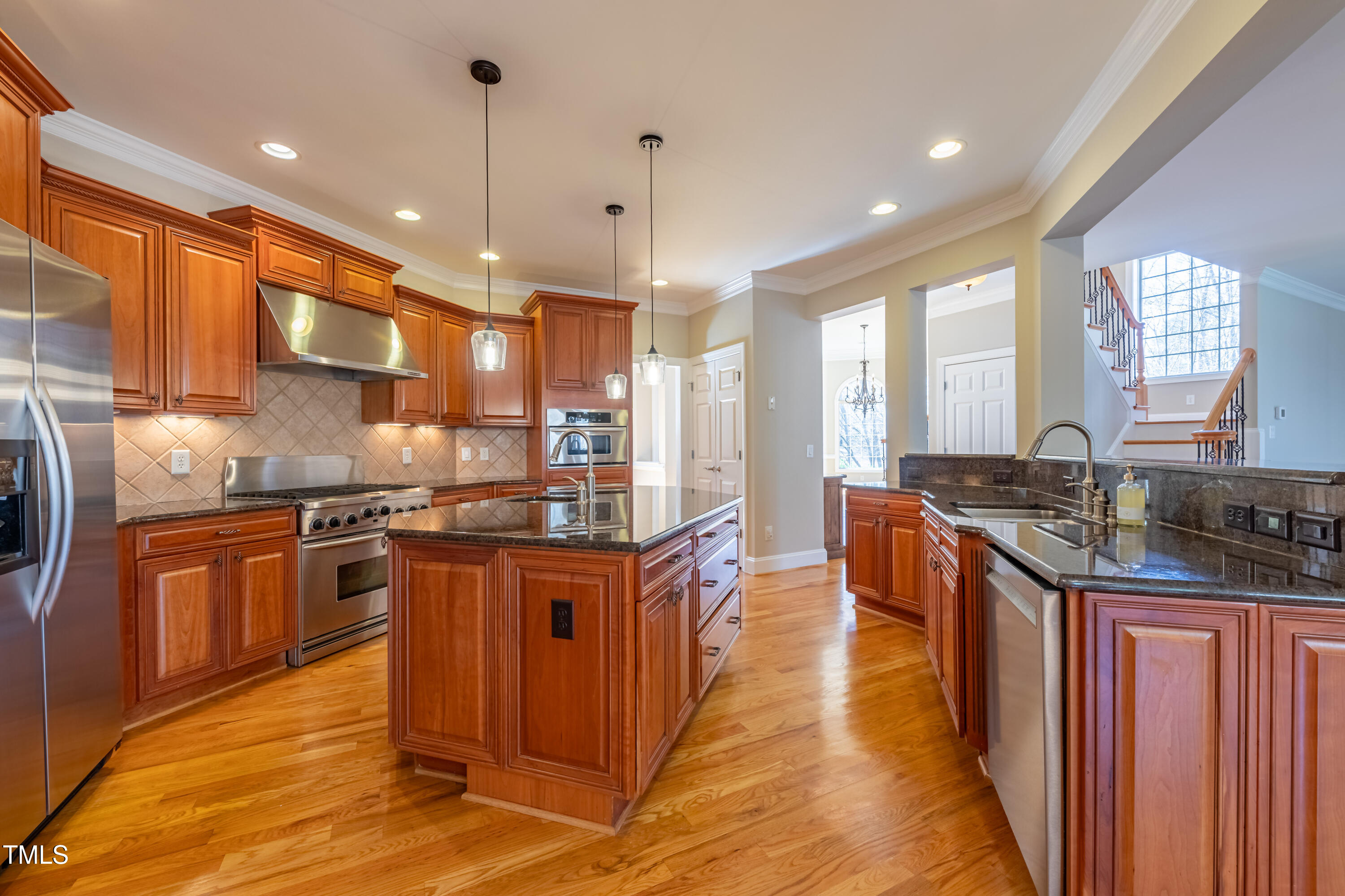 1408 Goldengate Court Raleigh, NC 27613 - Photo 15 of 64 a kitchen with stainless steel appliances granite countertop wooden cabinets a sink dishwasher a stove and a refrigerator