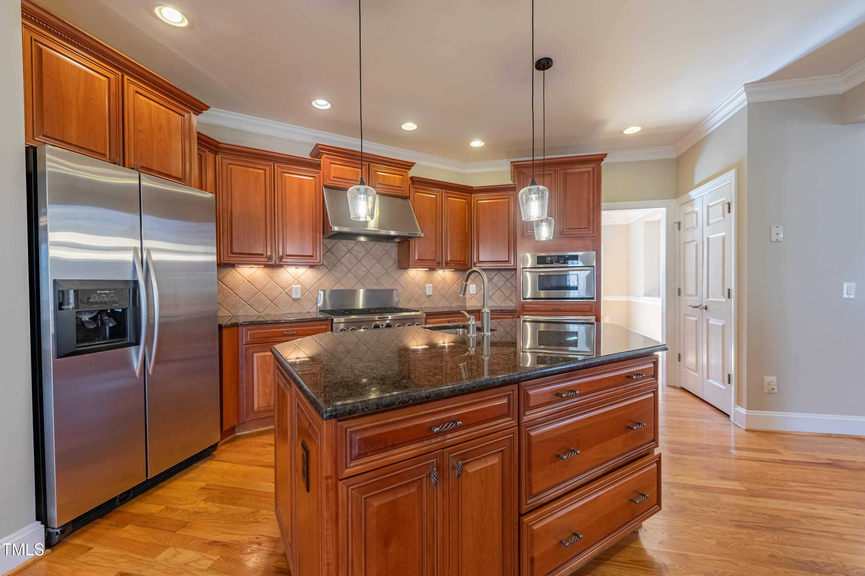 1408 Goldengate Court Raleigh, NC 27613 - Photo 16 of 64 a kitchen with stainless steel appliances granite countertop a sink a refrigerator and a stove