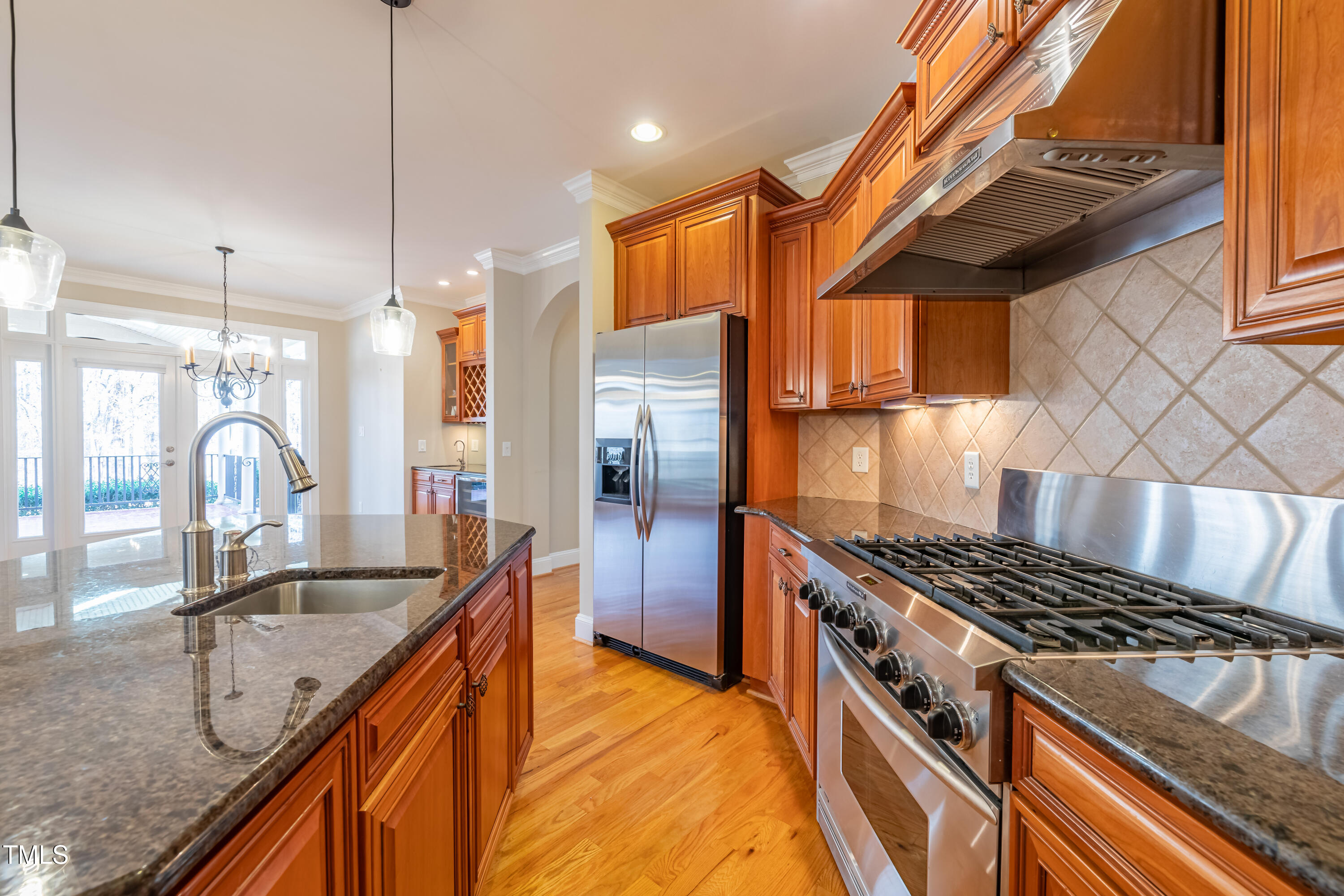 1408 Goldengate Court Raleigh, NC 27613 - Photo 18 of 64 a kitchen with stainless steel appliances granite countertop a sink a stove and a refrigerator