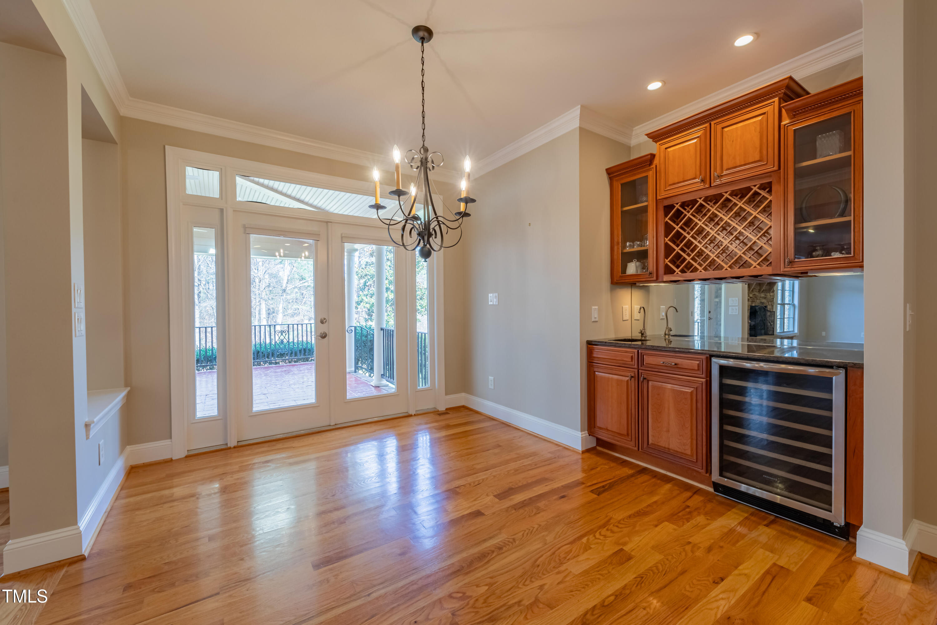 1408 Goldengate Court Raleigh, NC 27613 - Photo 20 of 64 a view of an empty room with glass door and wooden floor