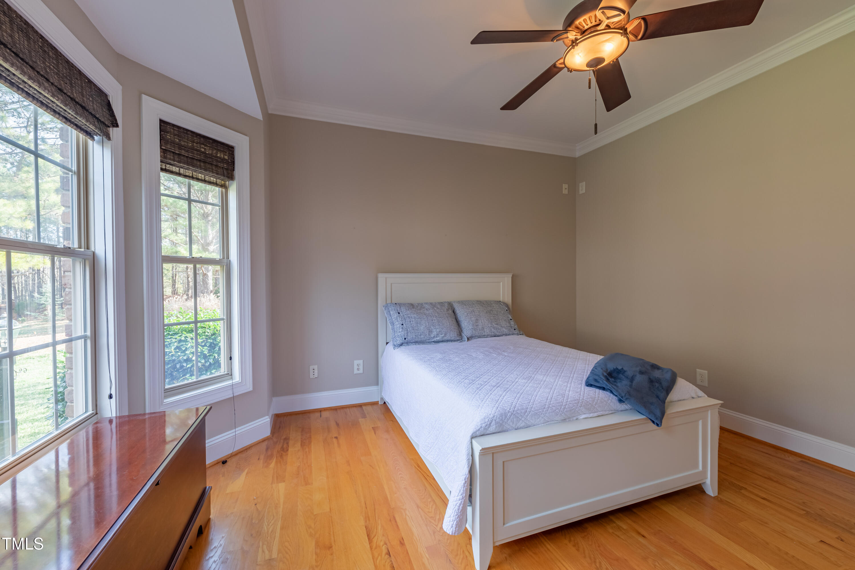1408 Goldengate Court Raleigh, NC 27613 - Photo 24 of 64 a bedroom with a bed and a chandelier fan
