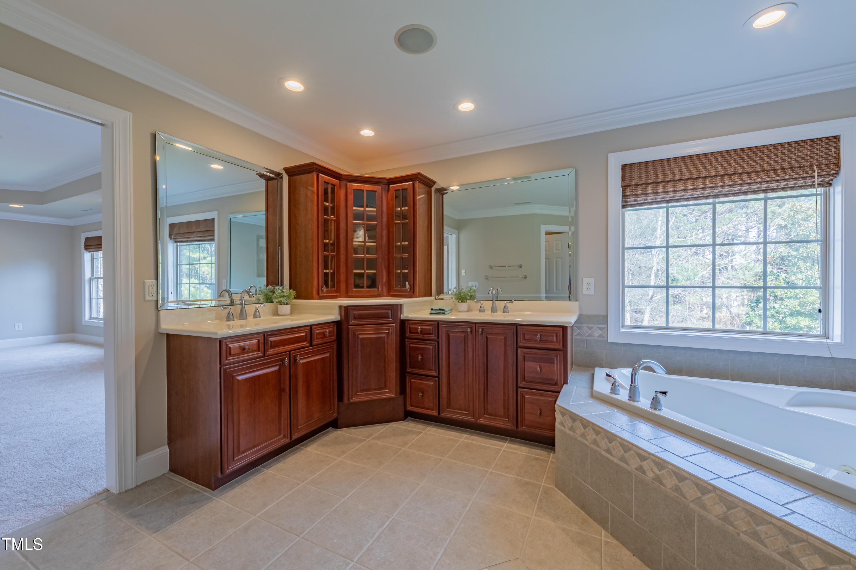 1408 Goldengate Court Raleigh, NC 27613 - Photo 31 of 64 a spacious bathroom with a tub sink and mirror