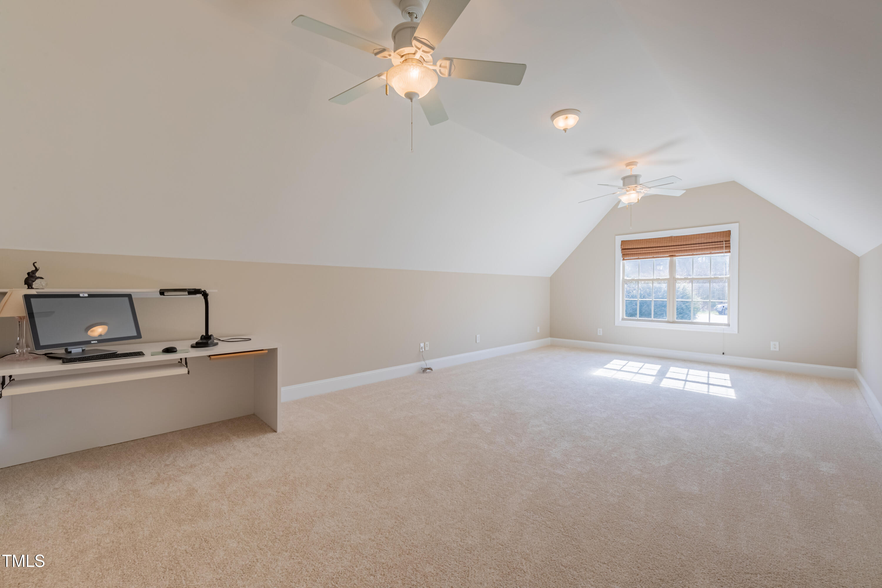 1408 Goldengate Court Raleigh, NC 27613 - Photo 40 of 64 an empty room with chandelier fan and windows