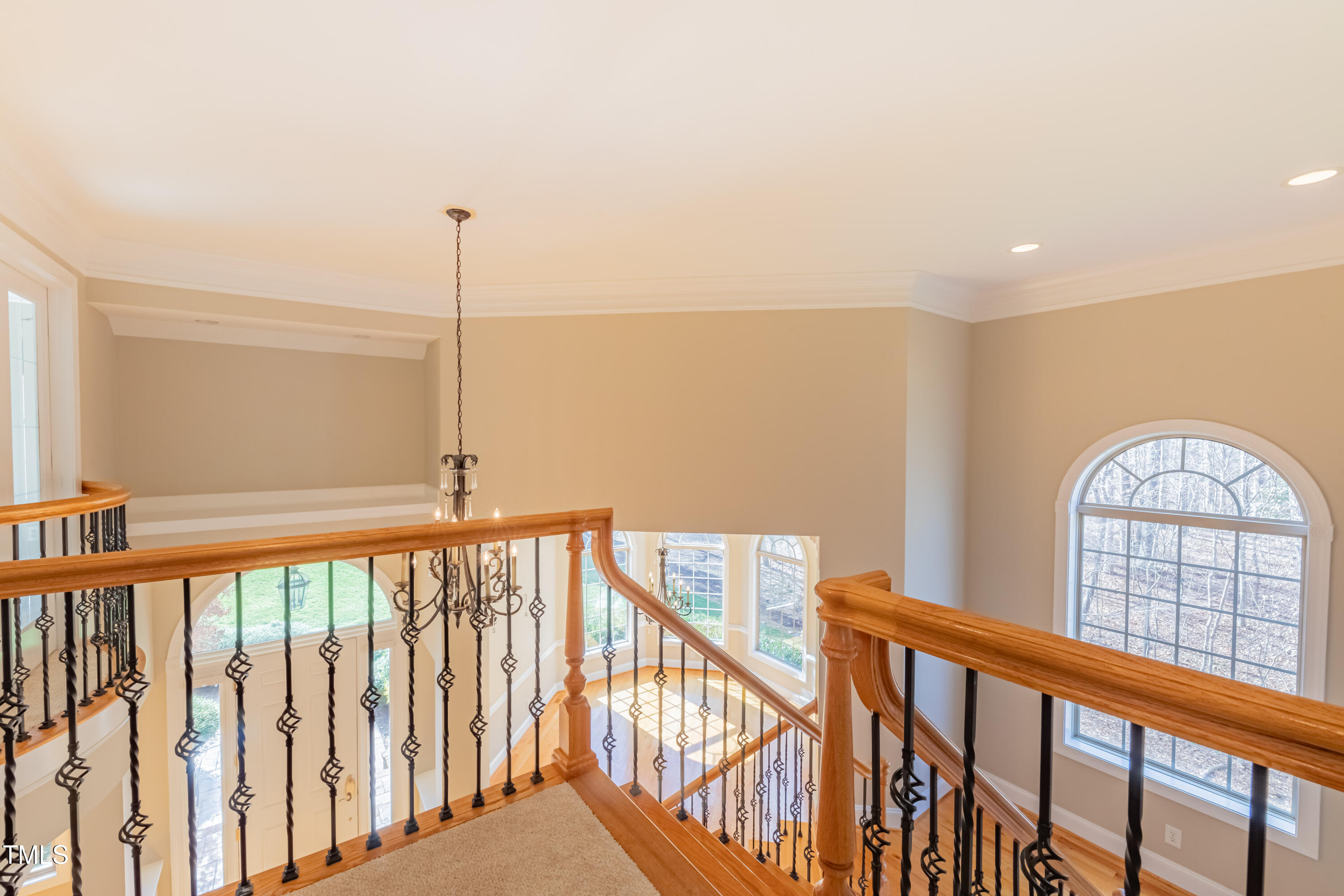 1408 Goldengate Court Raleigh, NC 27613 - Photo 47 of 64 a view of staircase with a floor to ceiling window and wooden floor