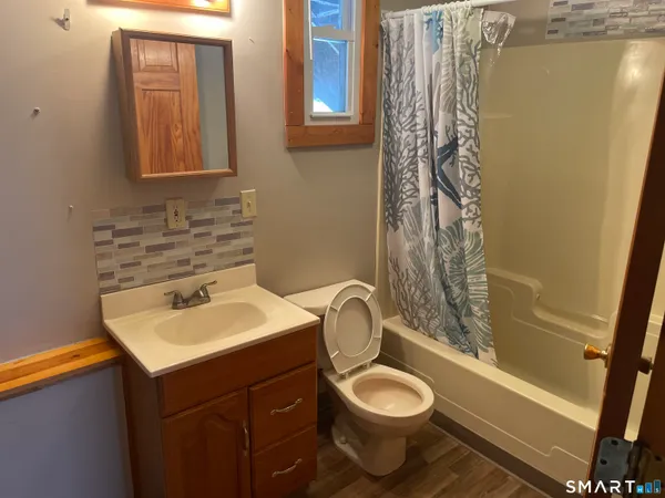 a bathroom with a sink toilet and shower