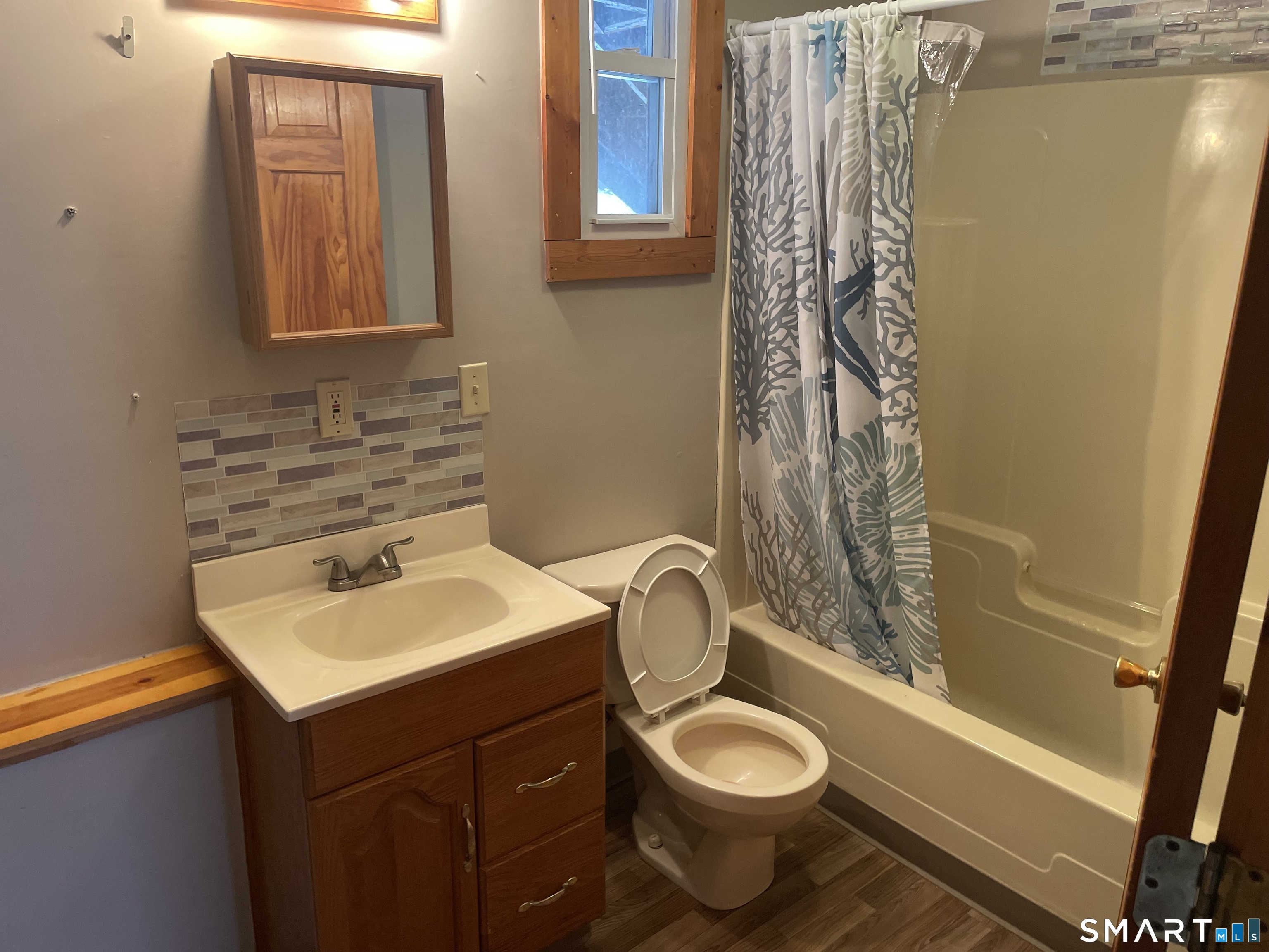 91 Division Street Ansonia, CT 06401 - Photo 11 of 22 a bathroom with a sink toilet and shower