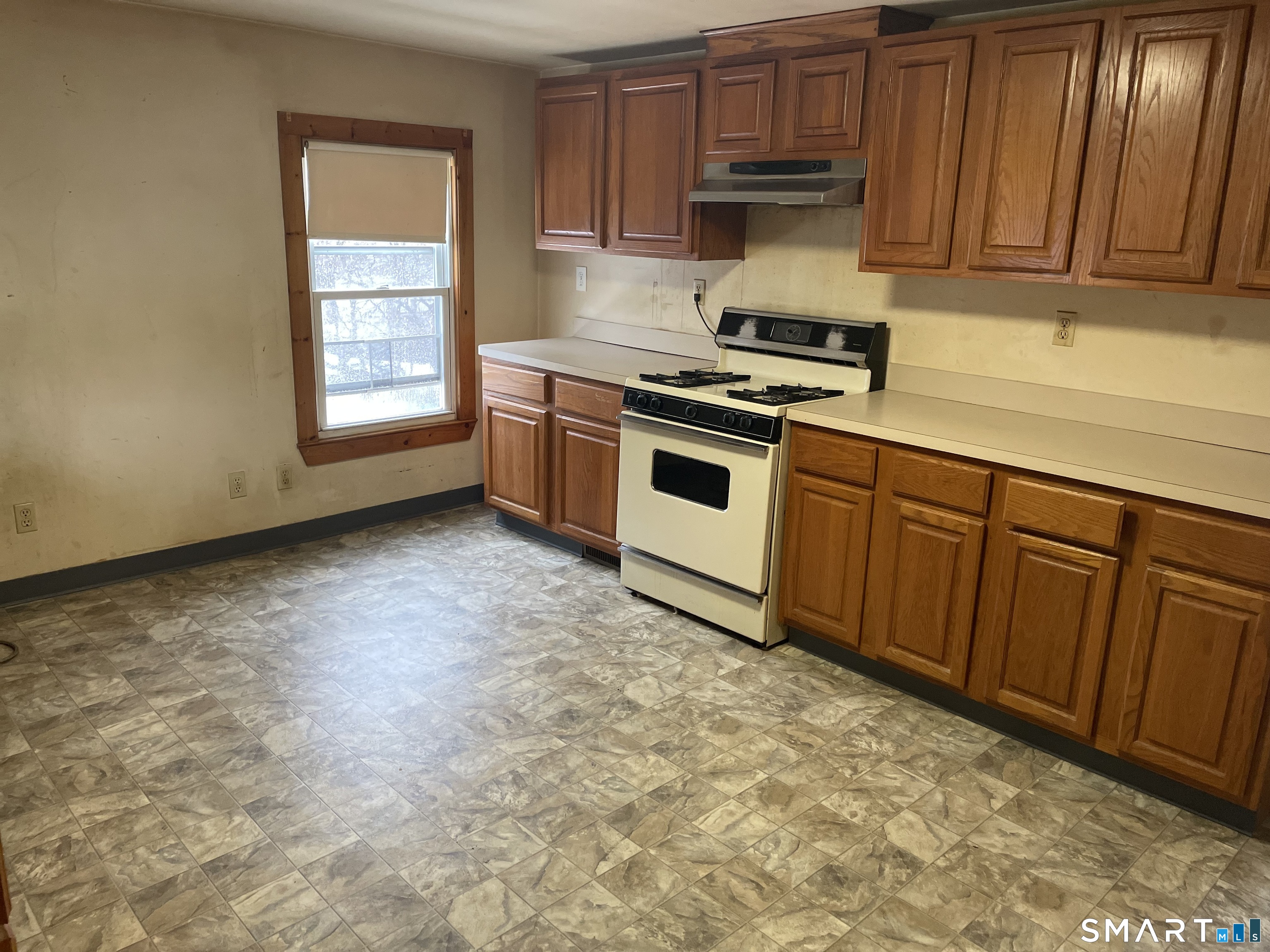 91 Division Street Ansonia, CT 06401 - Photo 14 of 22 a kitchen with granite countertop a sink cabinets and stainless steel appliances