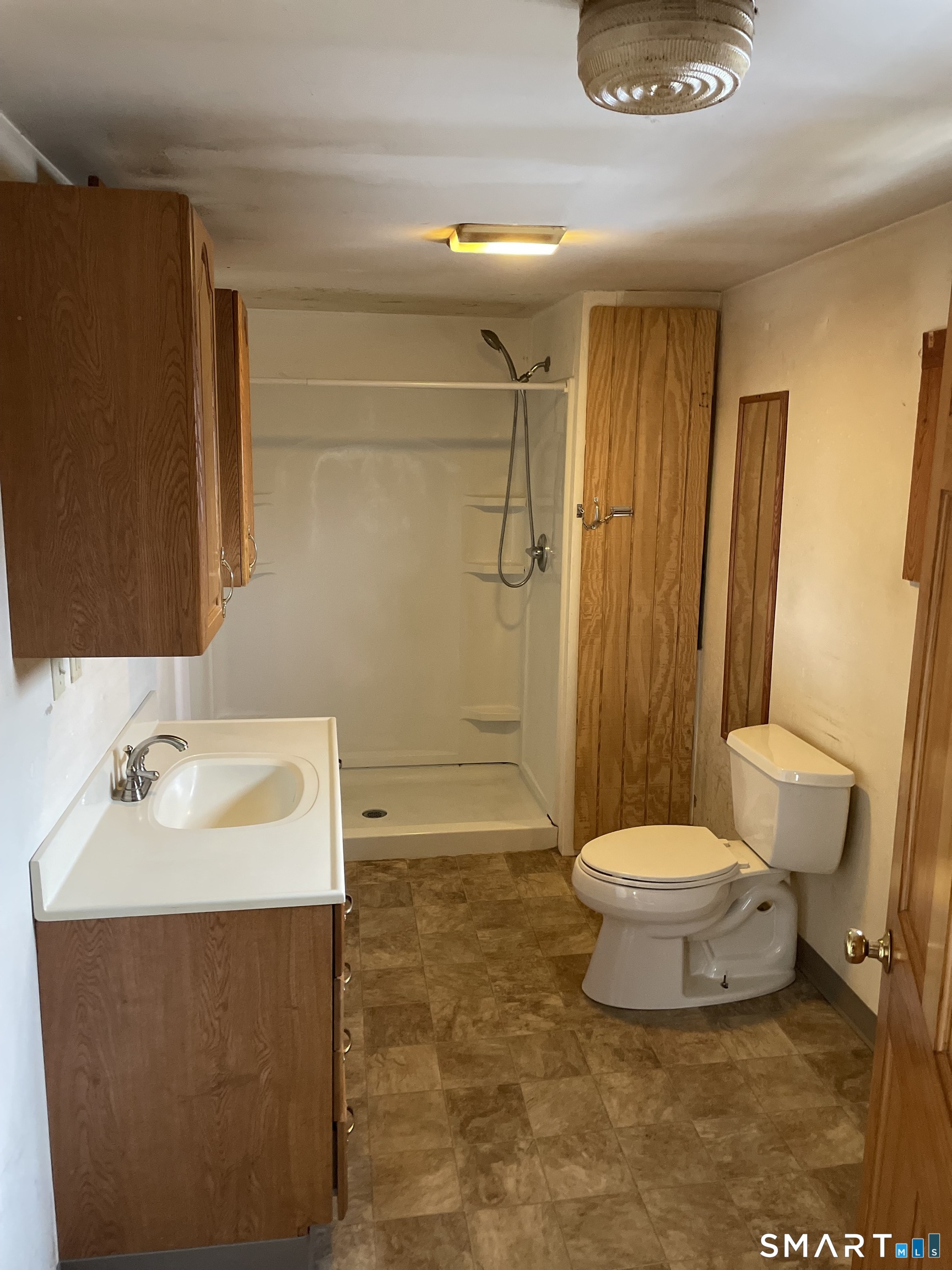 91 Division Street Ansonia, CT 06401 - Photo 15 of 22 a bathroom with a sink toilet and shower