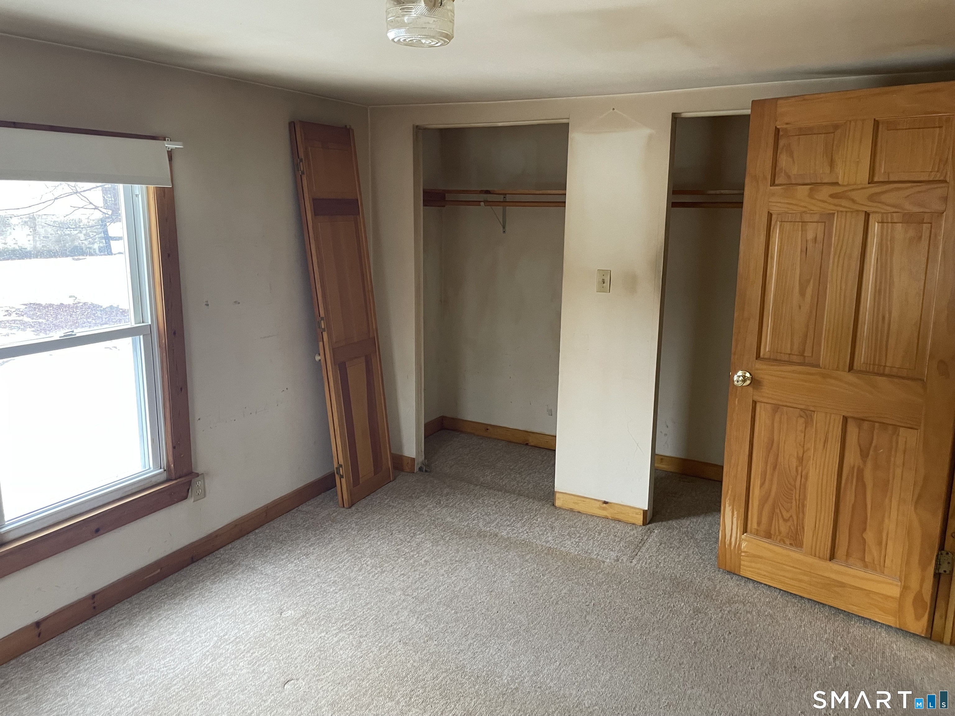 91 Division Street Ansonia, CT 06401 - Photo 19 of 22 an empty room with windows cabinet and front door