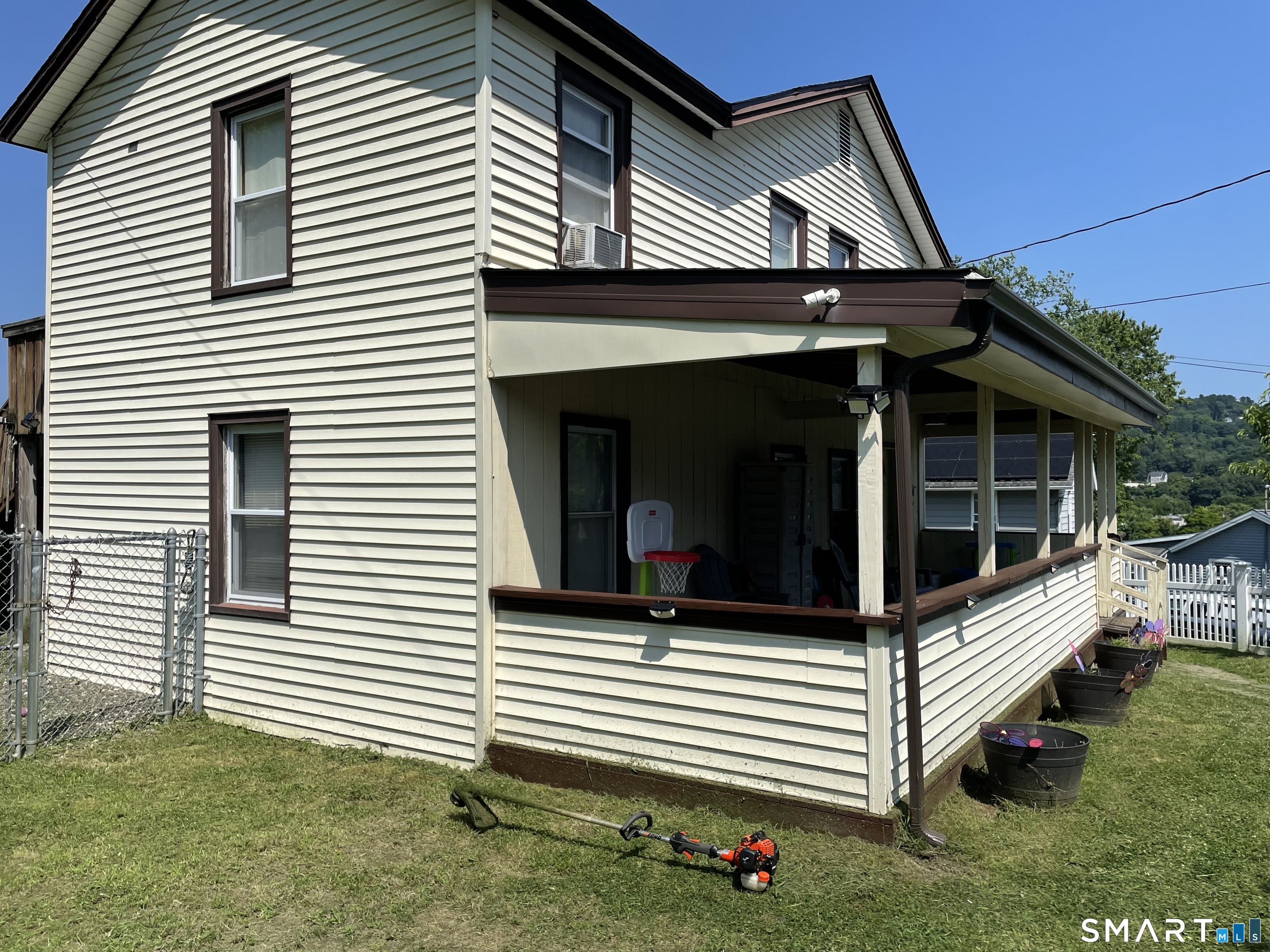 91 Division Street Ansonia, CT 06401 - Photo 2 of 22 a view of a house with a yard and wooden fence