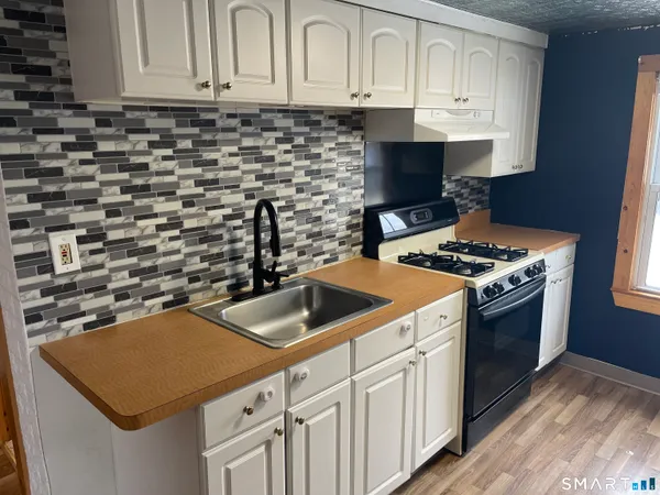 a kitchen with cabinets and appliances