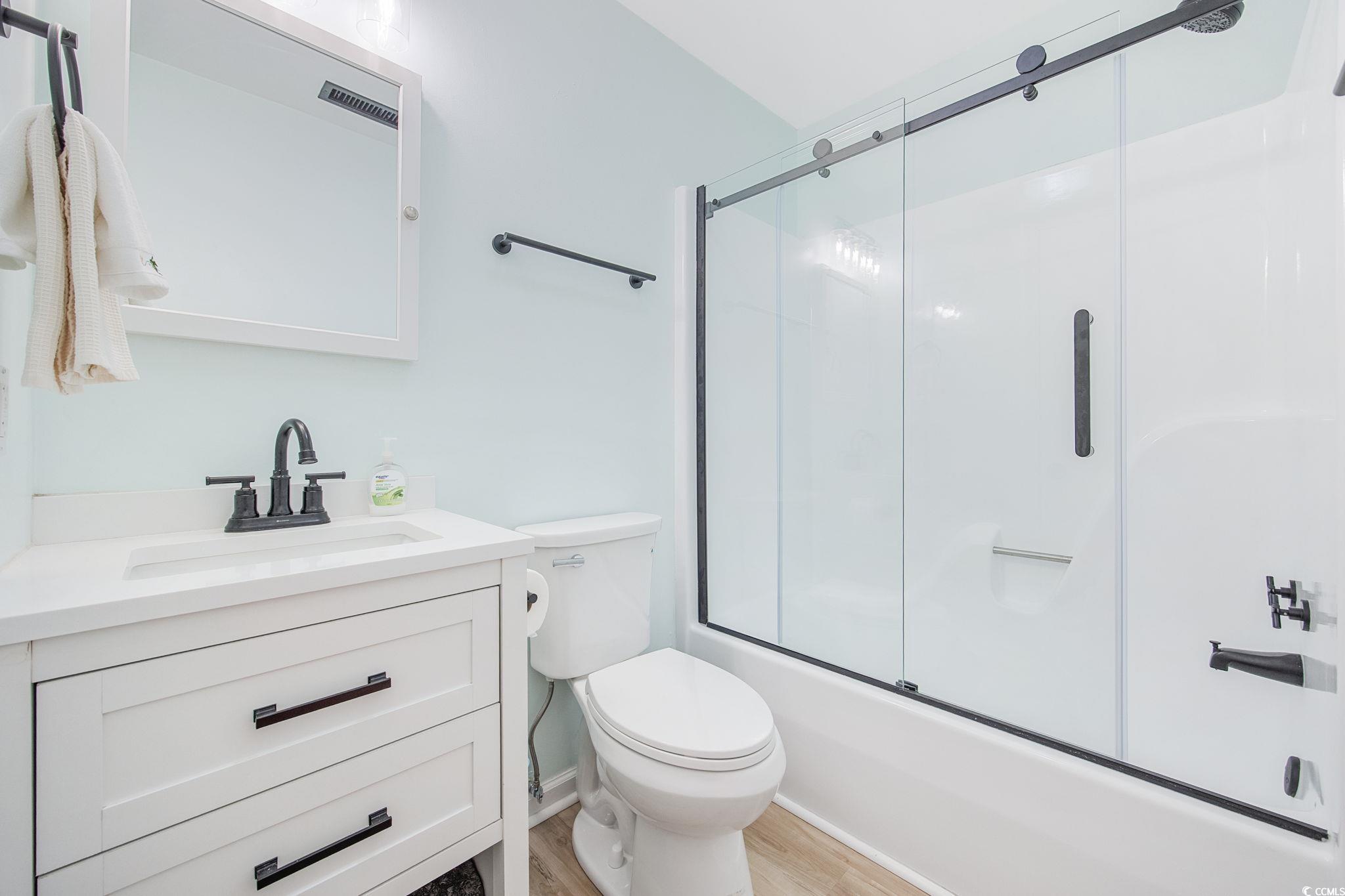 787 Causey Road Murrells Inlet, SC 29576 - Photo 18 of 40 Full bathroom featuring vanity, bath / shower combo with glass door, and light wood-style flooring