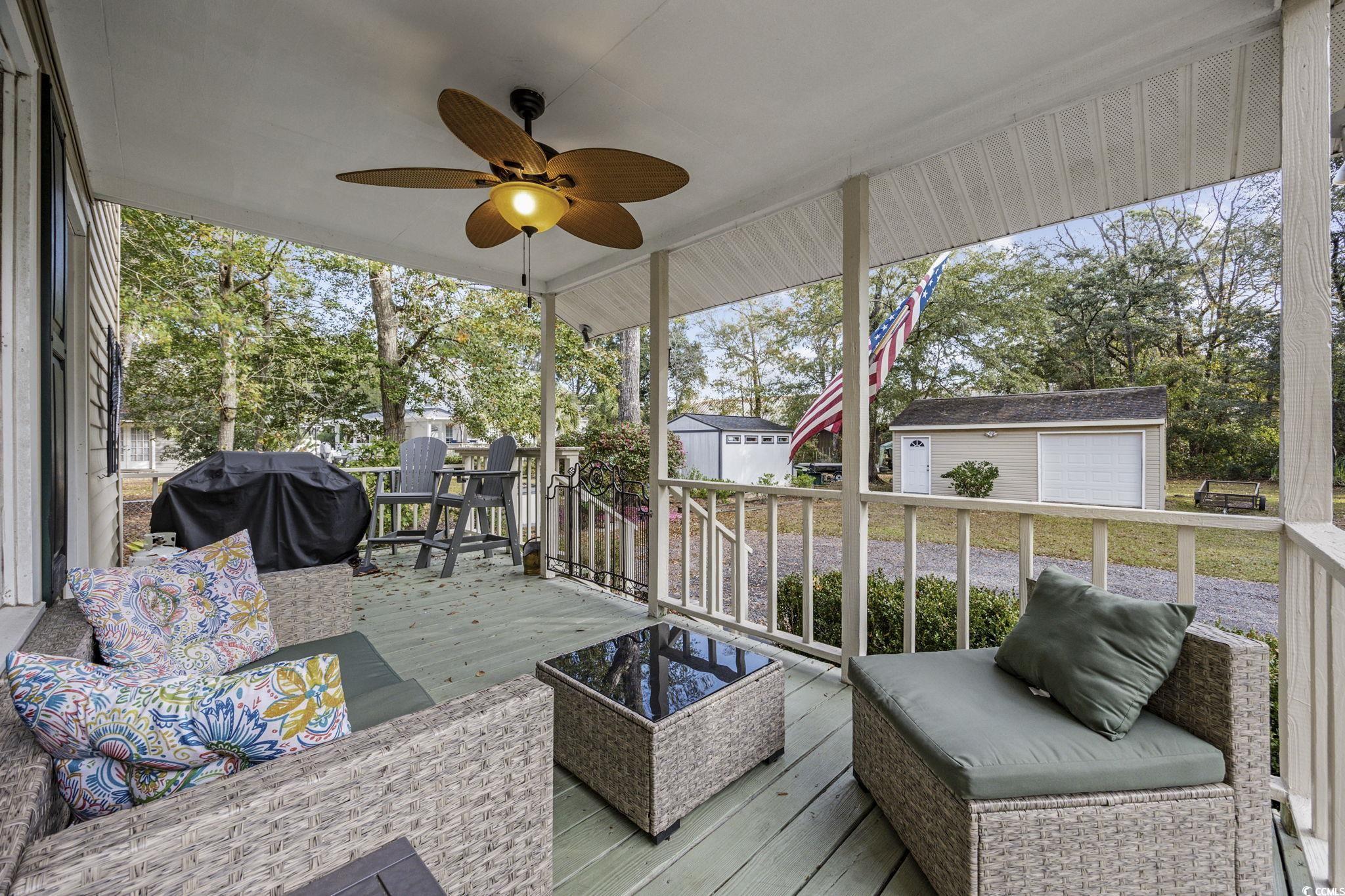 787 Causey Road Murrells Inlet, SC 29576 - Photo 23 of 40 Sunroom / solarium with a wooden deck, an outdoor hangout area, and healthy amount of natural light