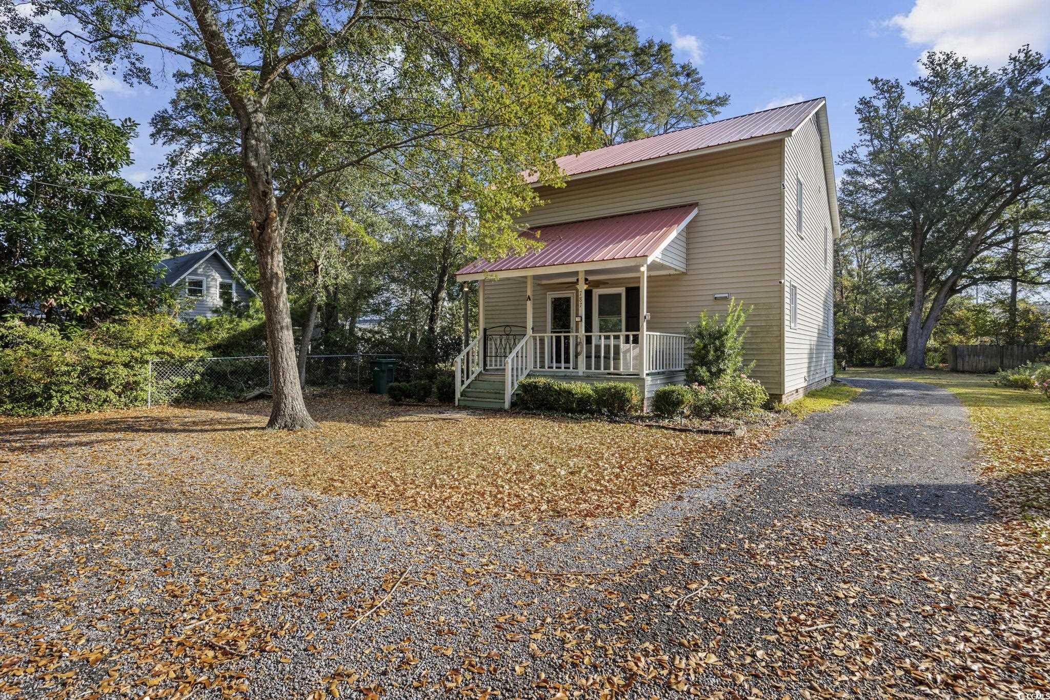 787 Causey Road Murrells Inlet, SC 29576 - Photo 4 of 40 View of front of property featuring a porch, a metal roof, and gravel driveway