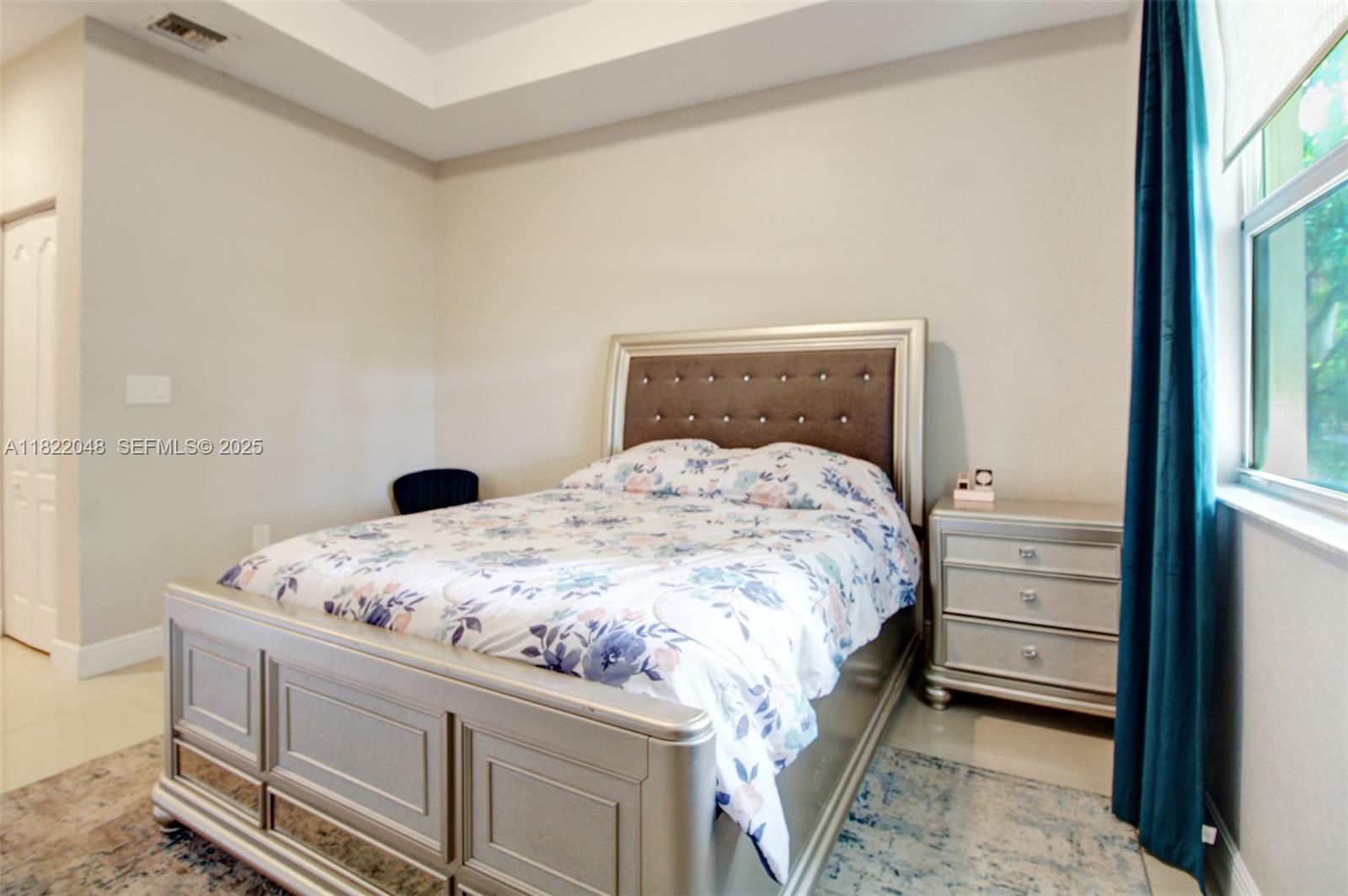 2131 Northeast 37th Road Homestead, FL 33033 - Photo 15 of 34 a bedroom with a bed and a window