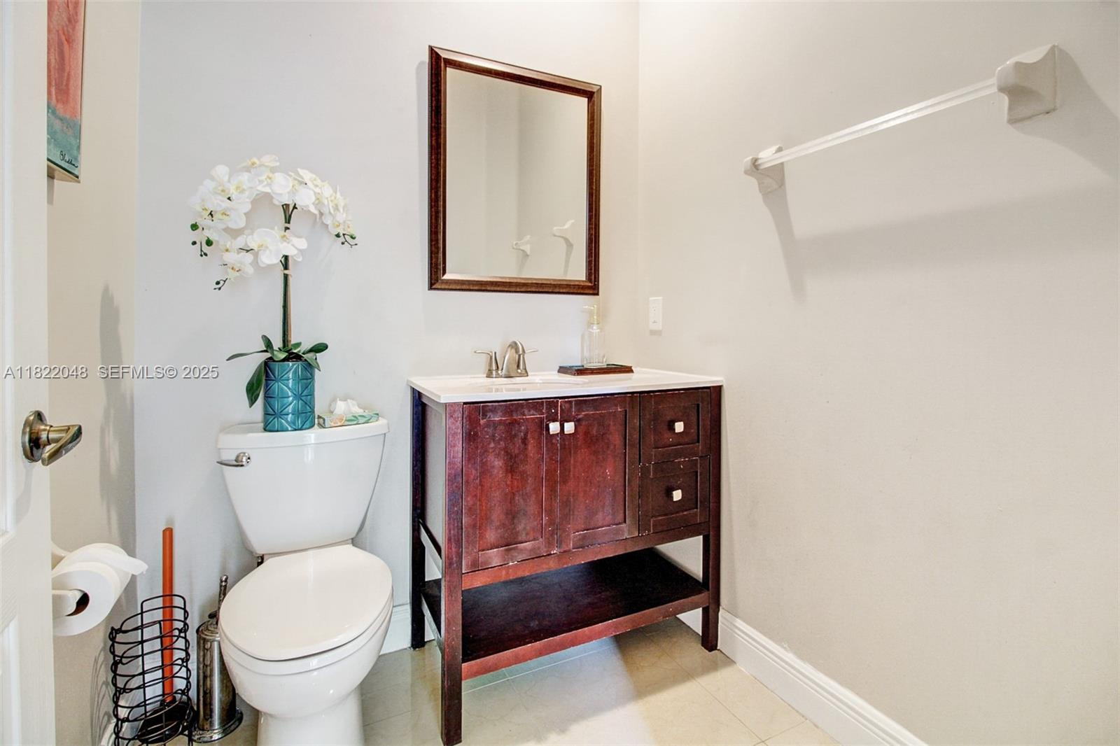 2131 Northeast 37th Road Homestead, FL 33033 - Photo 5 of 34 a bathroom with a toilet a sink and mirror