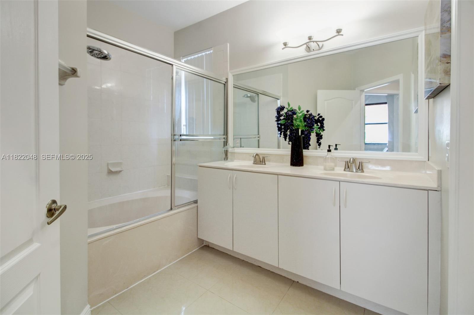2131 Northeast 37th Road Homestead, FL 33033 - Photo 10 of 34 a bathroom with a bathtub sink vanity and mirror