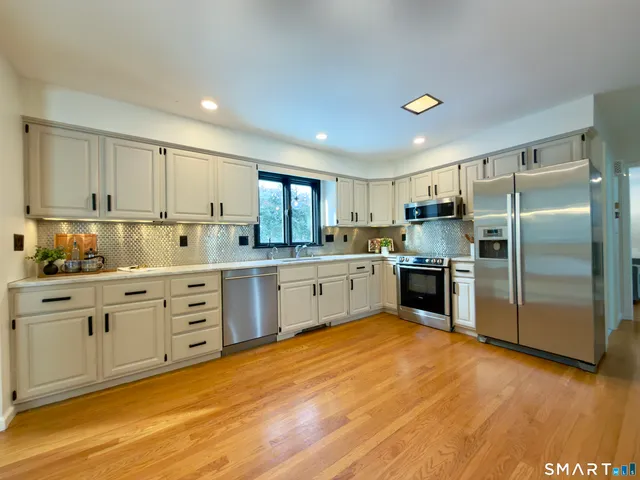 a front view of a house with garden and patio