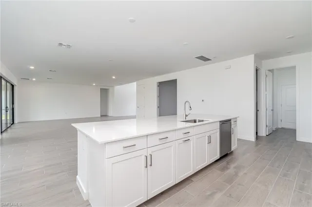 a kitchen with a sink stove and cabinets