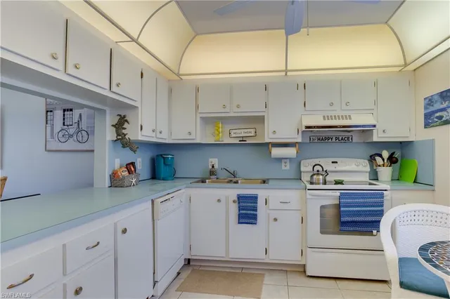 a kitchen with stainless steel appliances granite countertop a sink and cabinets
