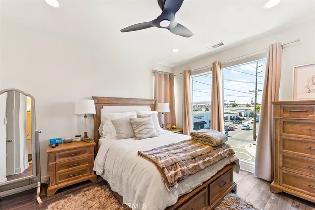 a bedroom with a bed and a large window