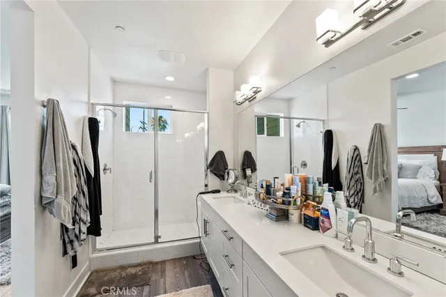 a bathroom with double vanity sink and a mirror