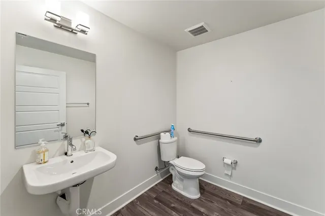 a white toilet sitting next to a bathroom sink