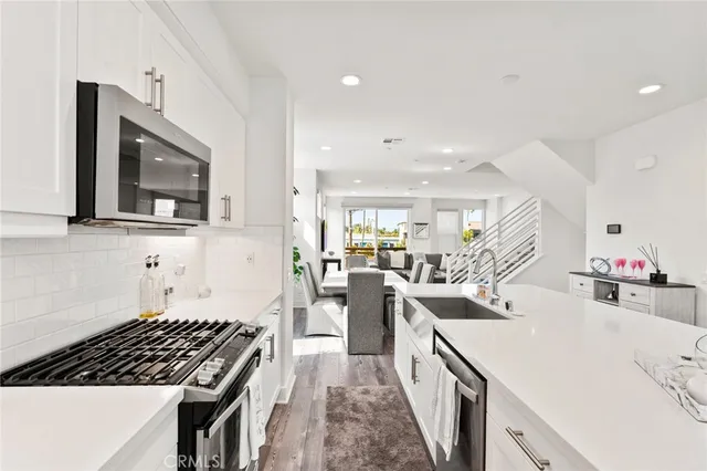 a kitchen with sink stove and cabinets