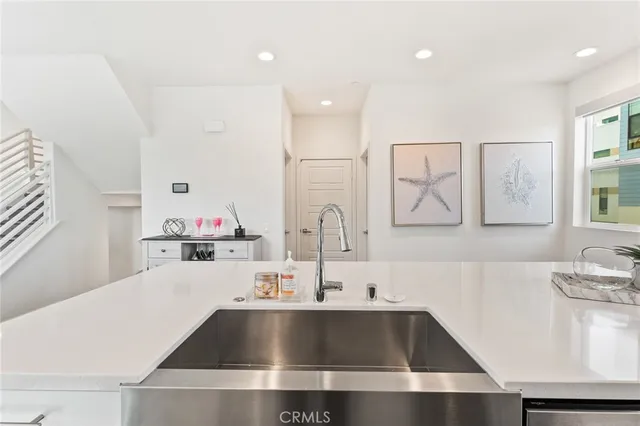 a kitchen with kitchen island a sink appliances and cabinets