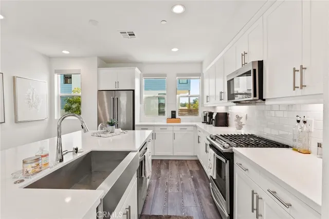 a kitchen with a sink stove top oven and refrigerator