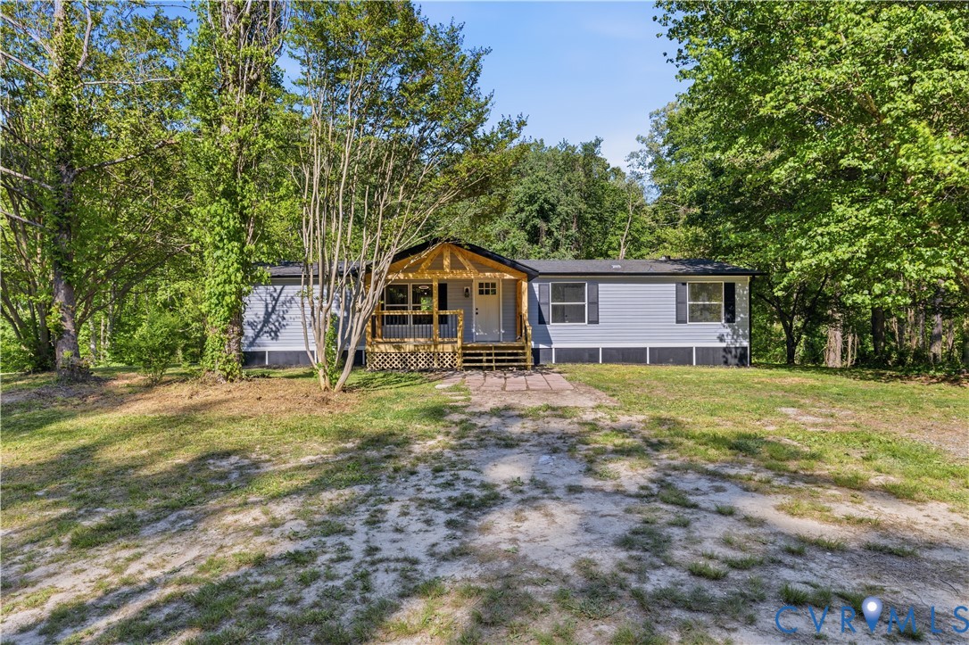 5599 Mountcastle Road Providence Forge, VA 23140 - Photo 1 of 1 a house with trees in front of it