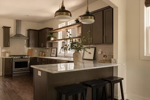 a kitchen with stainless steel appliances granite countertop a stove and a sink