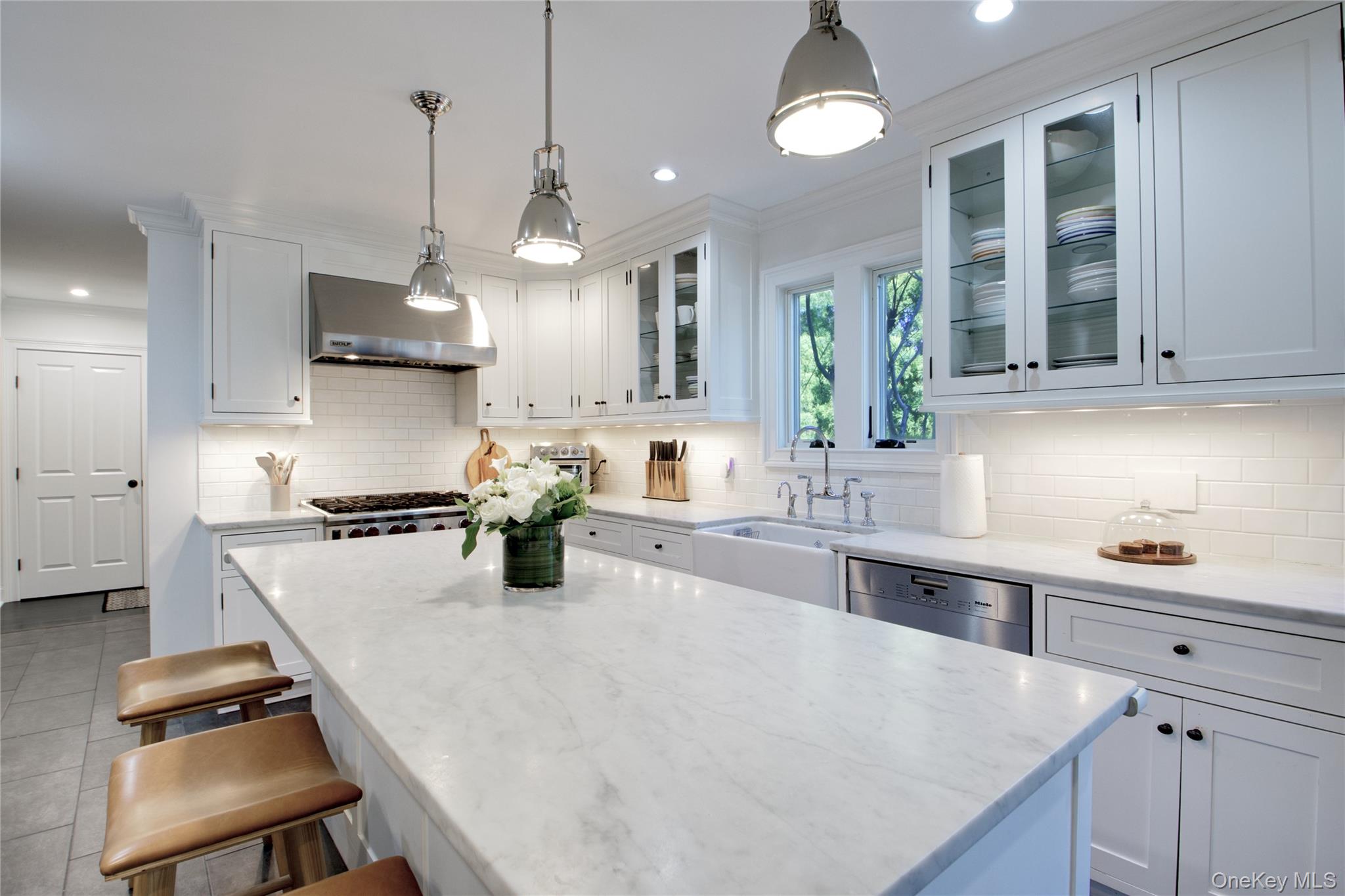 6 Flamingo Road East Hills, NY 11576 - Photo 12 of 37 a kitchen with a stove a sink a center island and cabinets