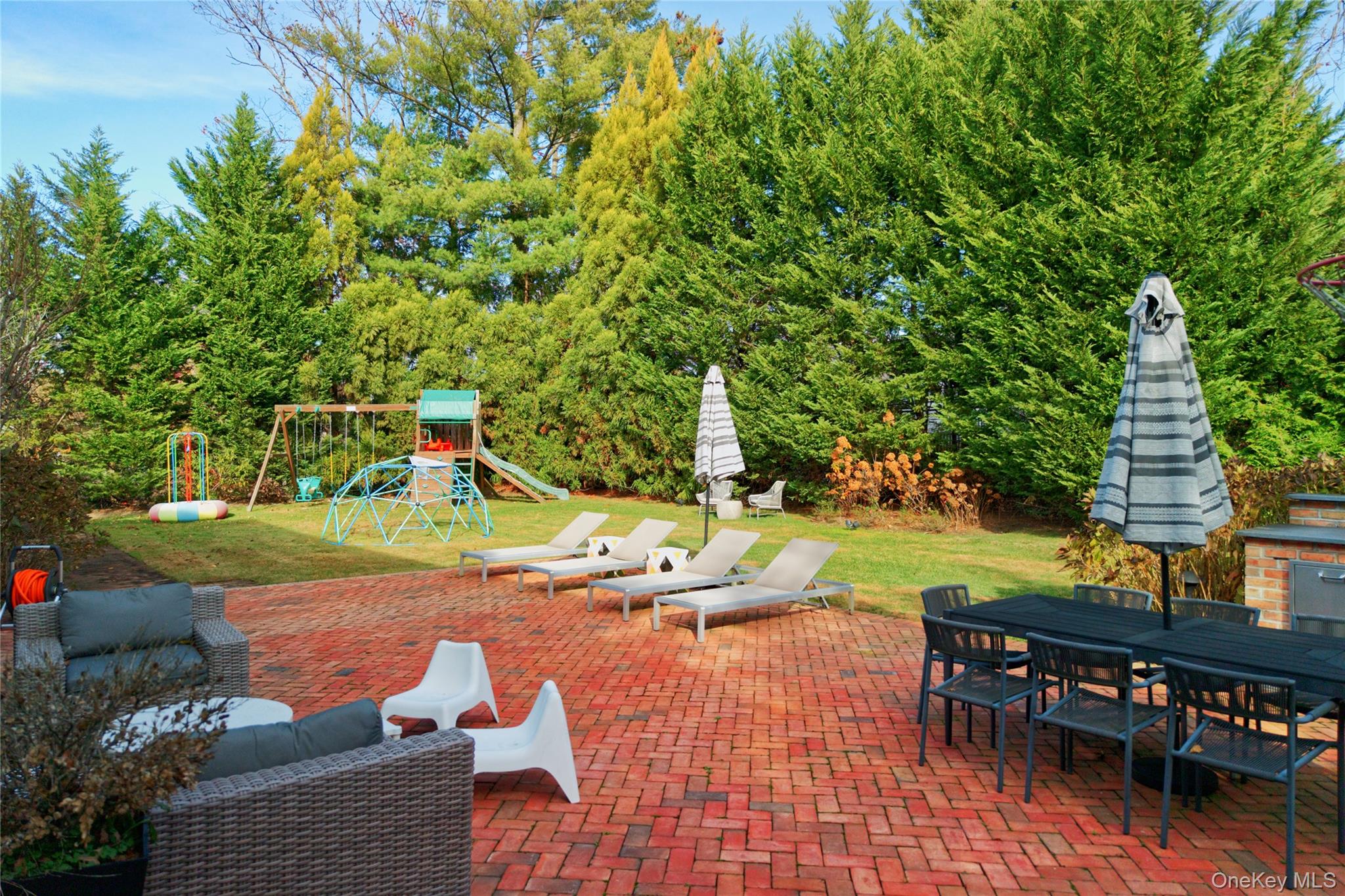6 Flamingo Road East Hills, NY 11576 - Photo 32 of 37 a view of a patio with table and chairs potted plants and large tree