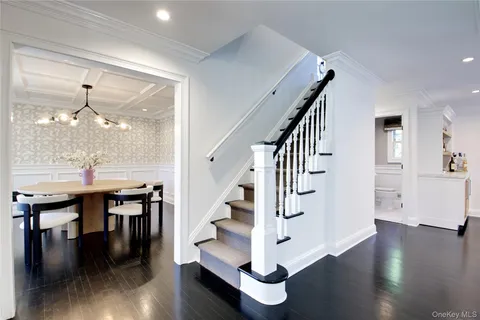 a view of entryway and dining room with wooden floor