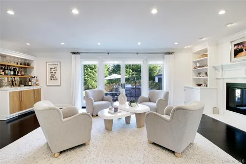 a living room with fireplace furniture and a flat screen tv