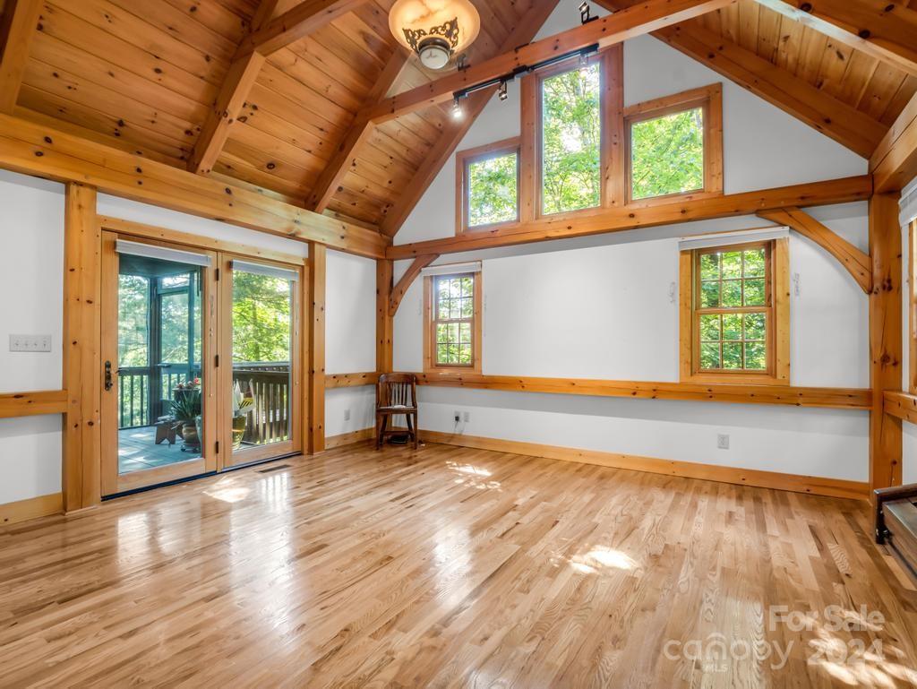 1065 South Cove Road Mill Spring, NC 28756 - Photo 13 of 48 a view of an empty room with wooden floor and a window