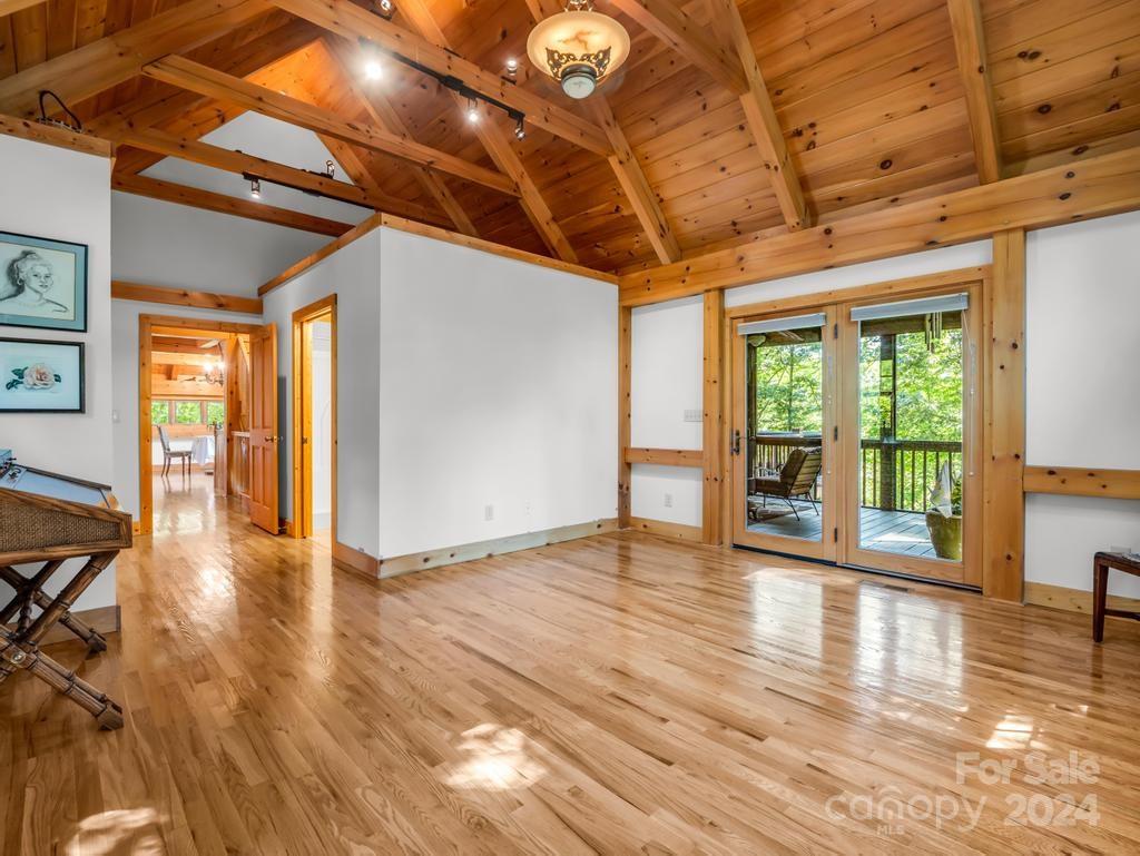 1065 South Cove Road Mill Spring, NC 28756 - Photo 14 of 48 a view of an empty room with wooden floor and a window