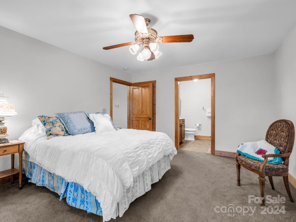 1065 South Cove Road Mill Spring, NC 28756 - Photo 20 of 48 a bedroom with a bed and window