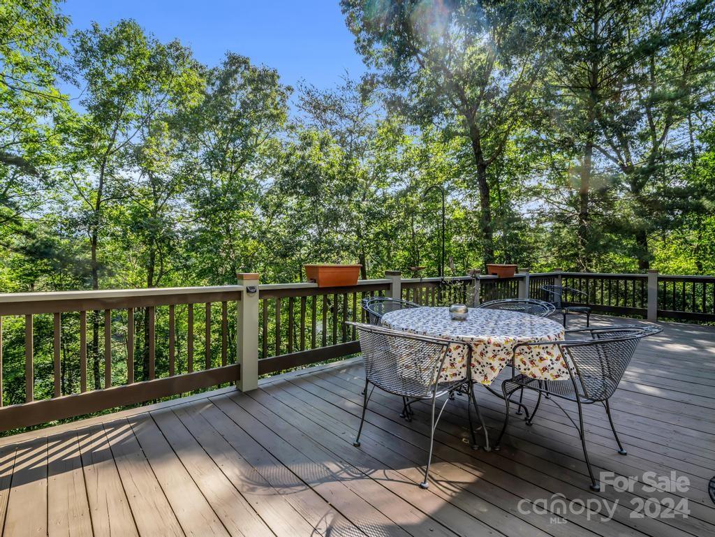 1065 South Cove Road Mill Spring, NC 28756 - Photo 31 of 48 a balcony with wooden floor table and chairs