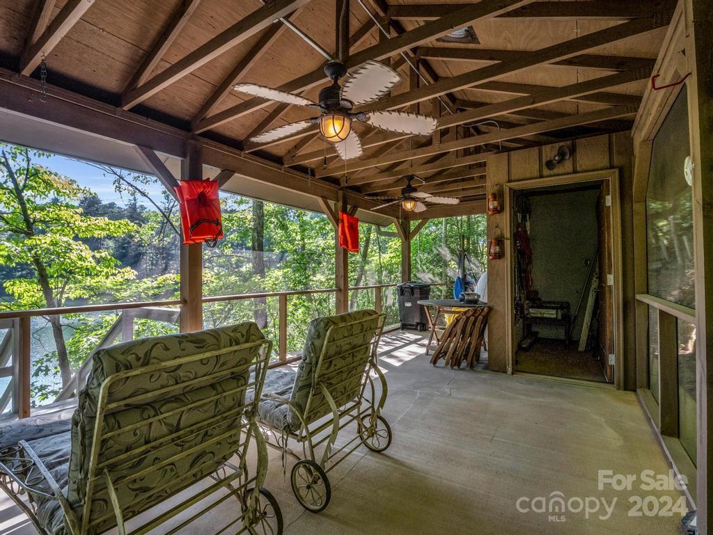 1065 South Cove Road Mill Spring, NC 28756 - Photo 41 of 48 a view of a chairs and table in patio with wooden fence