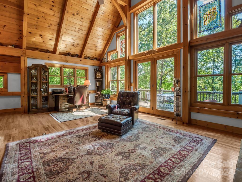 1065 South Cove Road Mill Spring, NC 28756 - Photo 5 of 48 a living room with furniture large windows and wooden floor