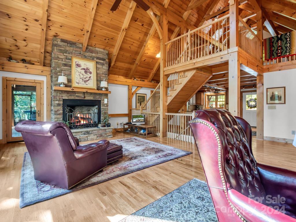 1065 South Cove Road Mill Spring, NC 28756 - Photo 7 of 48 a living room with furniture a fireplace and a table