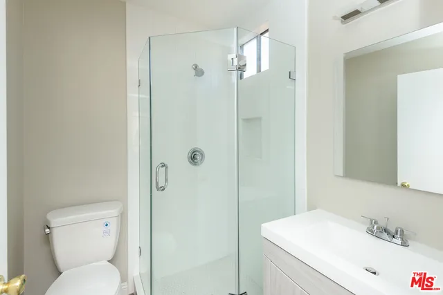 a bathroom with a toilet sink shower and granite