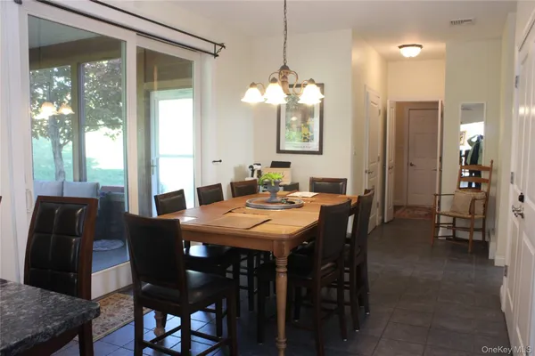 a view of a dining room with furniture and window